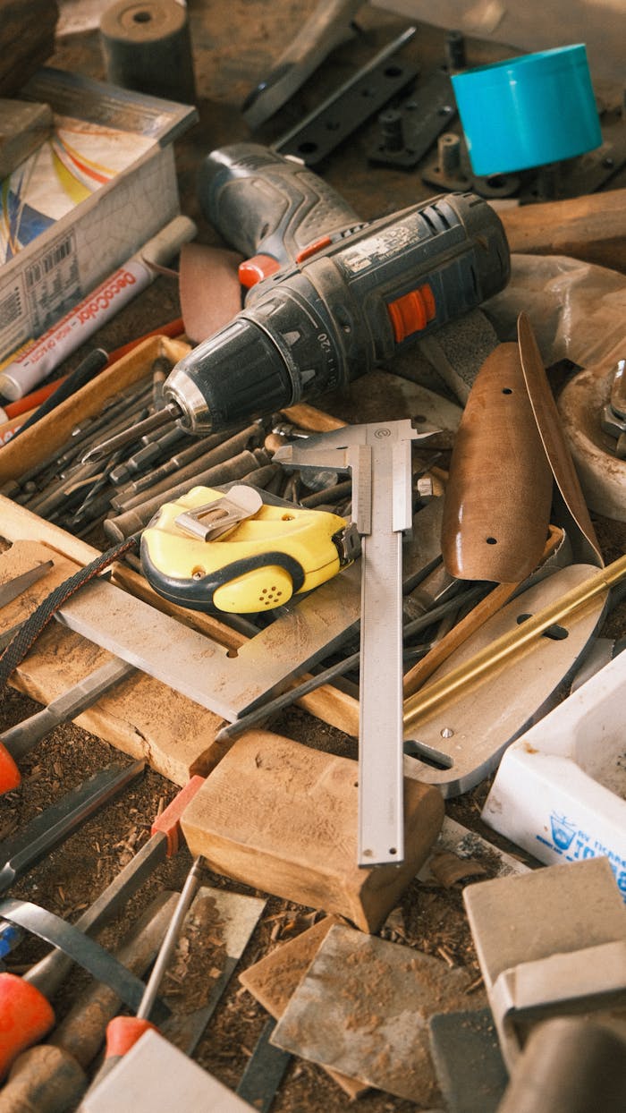 A collection of carpentry tools on a messy workbench showcasing craftsmanship and work in progress.